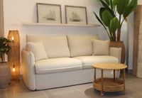 LUNA sofa bed in beige upholstery styled in a warm Mediterranean living room.