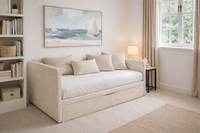 JUNO upholstered nest bed with pull-out drawer and integrated storage compartment in a bright bedroom setting.